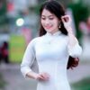 pexels photo 899757 899757 A woman in a white Ao Dai poses gracefully outdoors, showcasing traditional Vietnamese fashion.